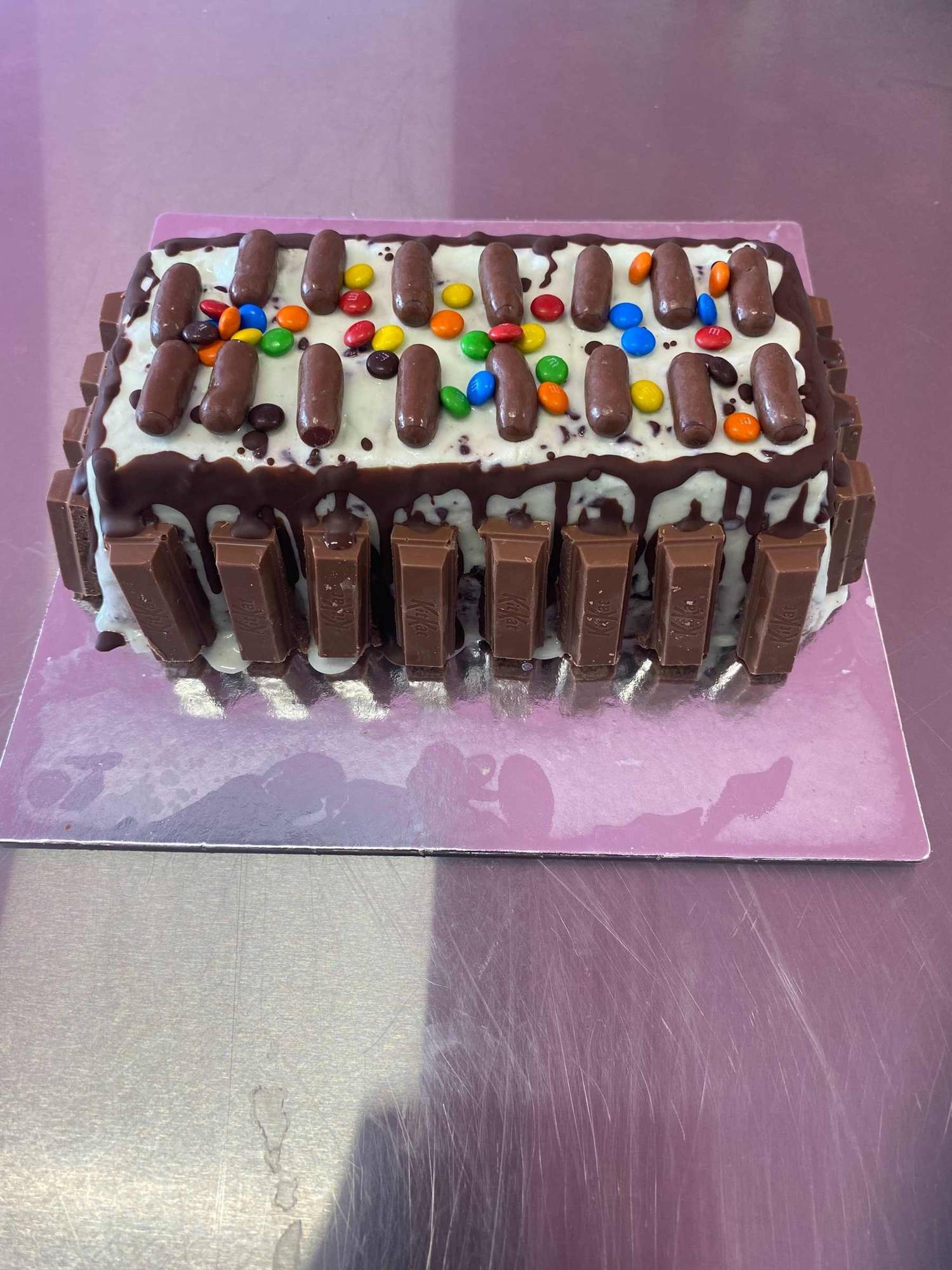 A gelato cake wrapped in chocolate bars