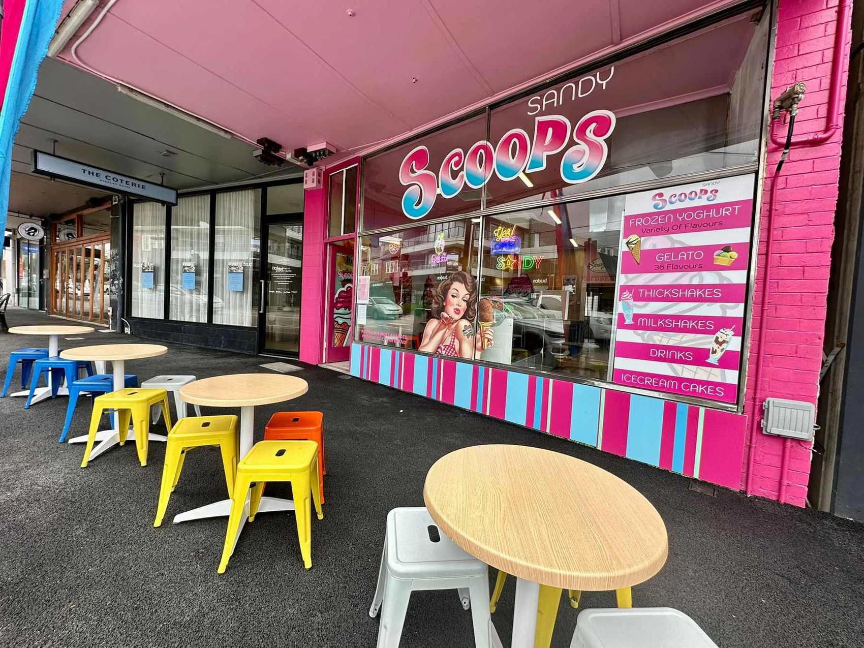 The pink and blue shopfront on Bay Road with tables out the front