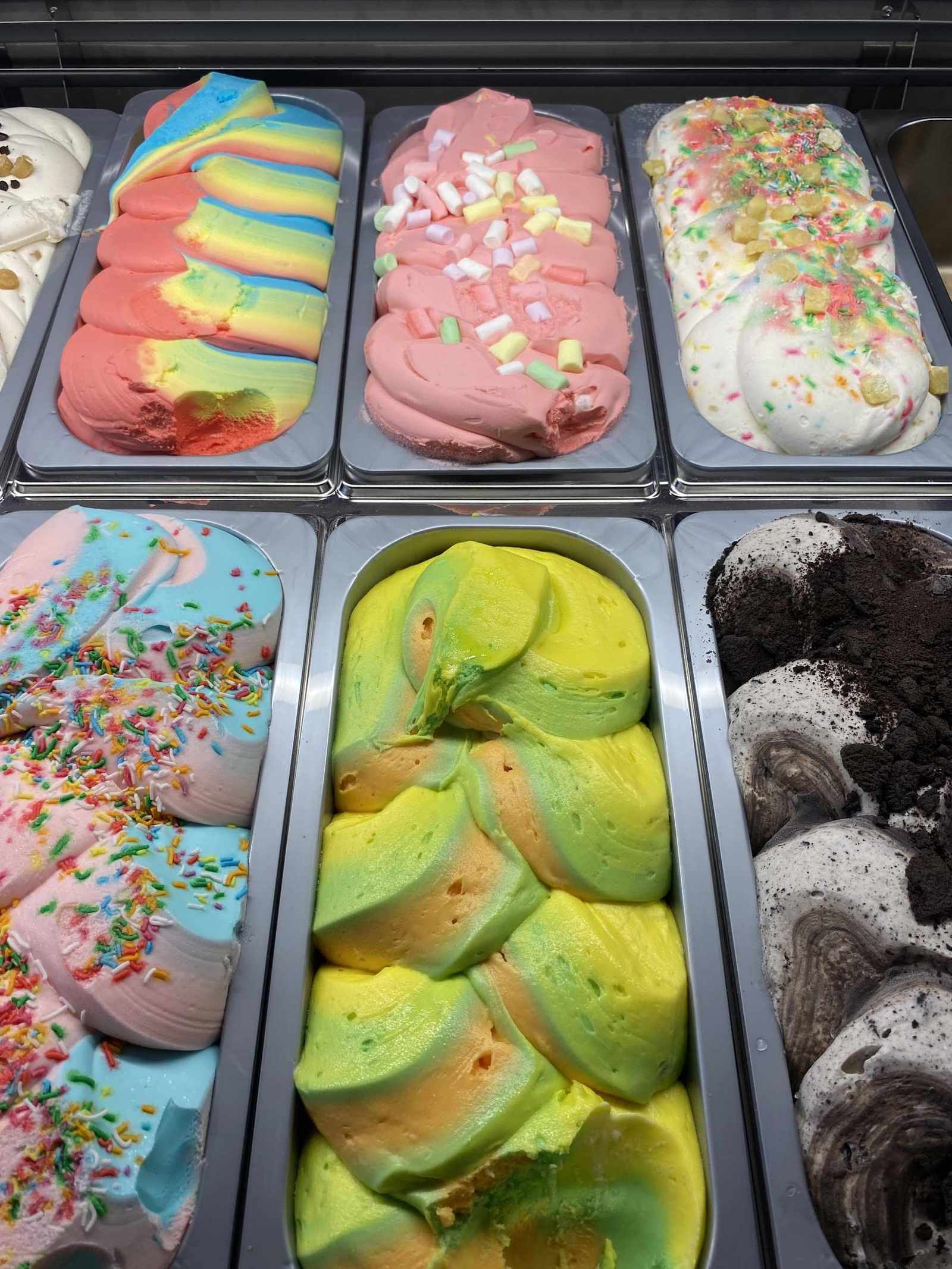 Tubs of colourful gelato in the cabinet
